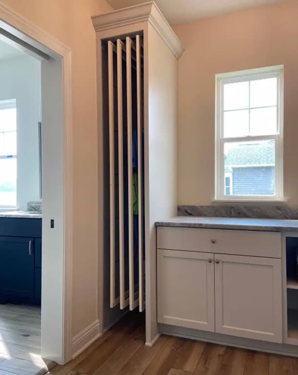 DryAway rack's rods extended outward in a hallway nook, showing the vertical drying matrix configuration