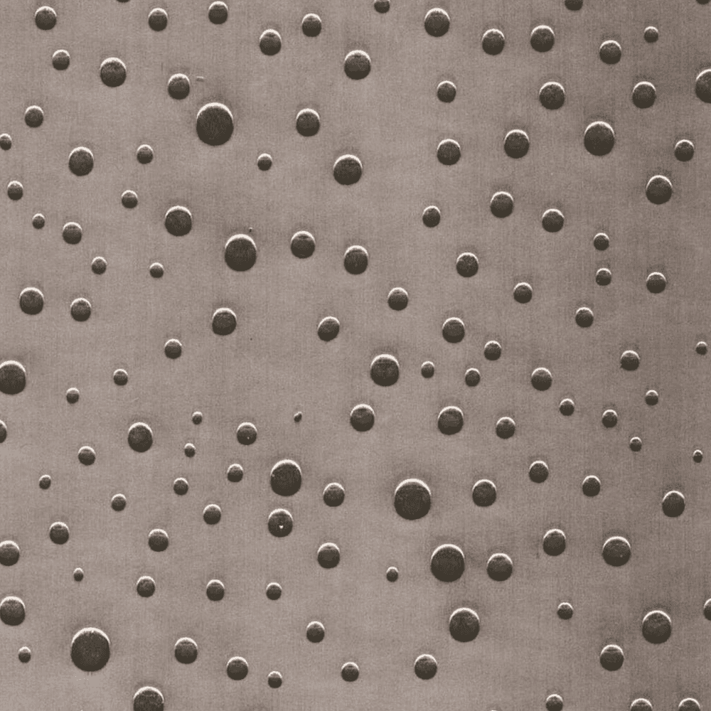 Embossed metal surface for wall panels and countertops