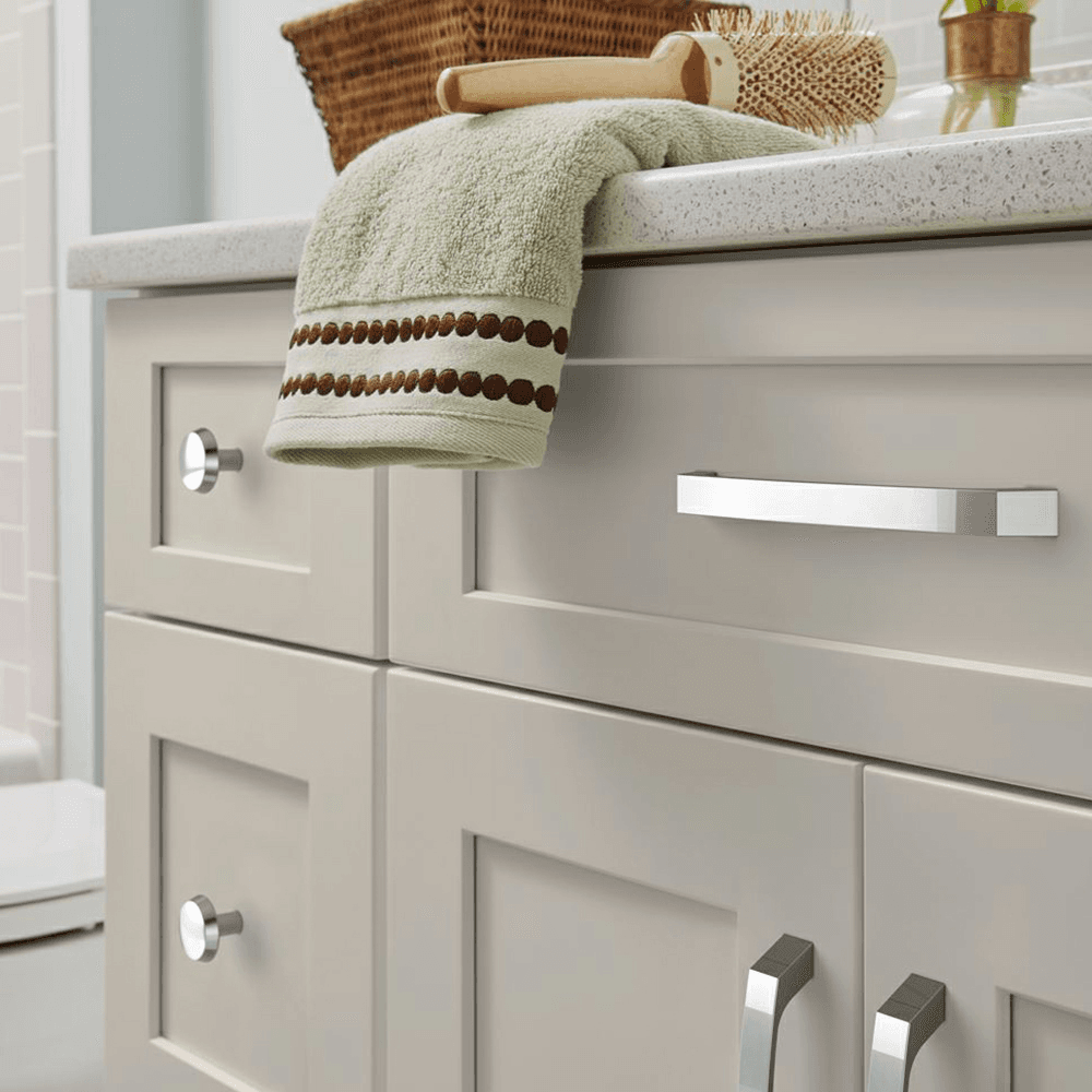 Amerock Premise Cabinet Pull in Polished Chrome on Wood Background