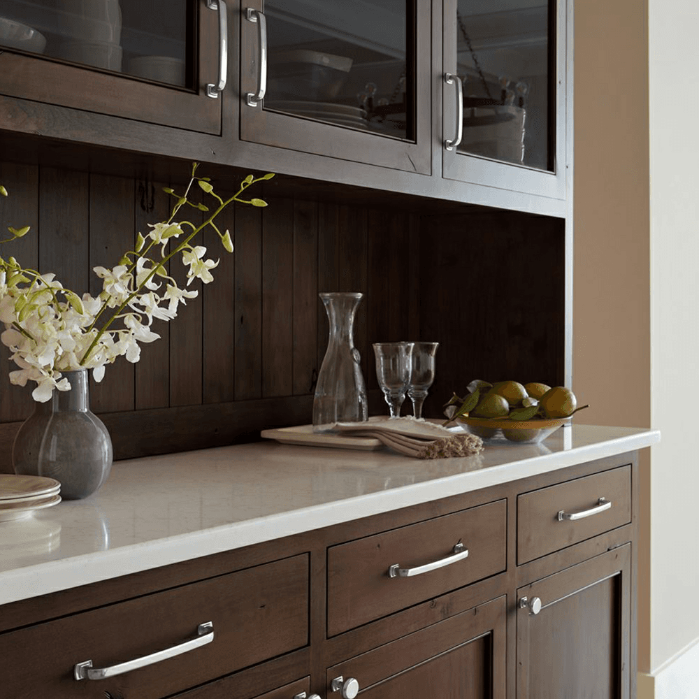 Amerock Surpass Knob in Satin Nickel Finish featuring bowing, rounded forms and square pedestal feet