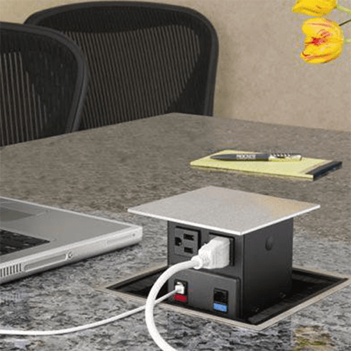 Spring-loaded PCS grommet kit with square cap and flange in satin stainless steel finish for power, data and voice access.