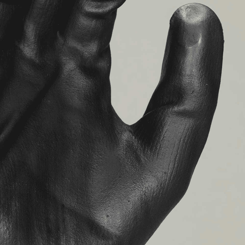 Hand holding gray and black gloves with foam nitrile coating