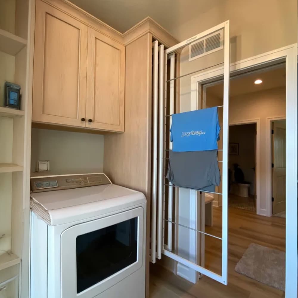 DryAway pullout cabinet drying system in retracted position showing space-efficient laundry room organization