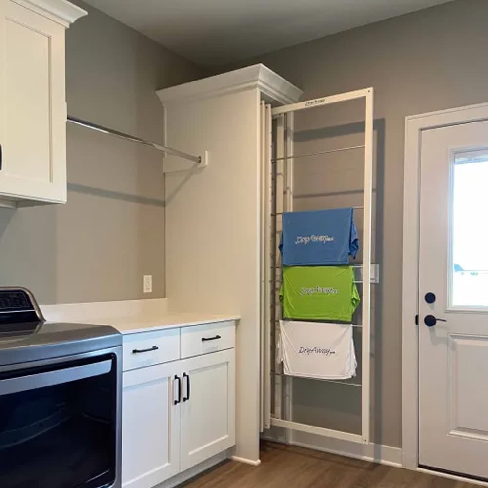 DryAway vertical drying rack showcasing three t-shirts for space-saving and organized laundry solutions in modern room